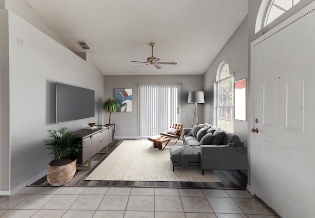 294 San Gabriel St, Winter Springs, FL 32708 - living area featuring a ceiling fan, vaulted ceiling, a textured ceiling, and light tile patterned flooring