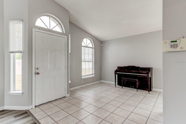 294 San Gabriel St, Winter Springs, FL 32708 - entrance foyer featuring vaulted ceiling, a textured ceiling, and light tile patterned floors