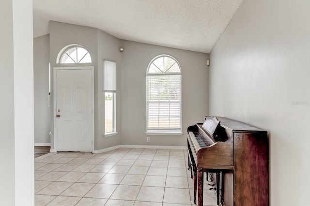 294 San Gabriel St, Winter Springs, FL 32708 - foyer with healthy amount of natural light, a textured ceiling, light tile patterned floors, and lofted ceiling