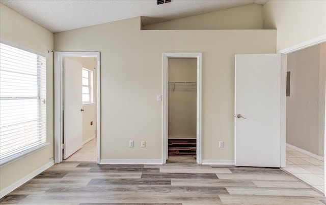 294 San Gabriel St, Winter Springs, FL 32708 - unfurnished bedroom featuring vaulted ceiling, a spacious closet, light wood-type flooring, and a closet