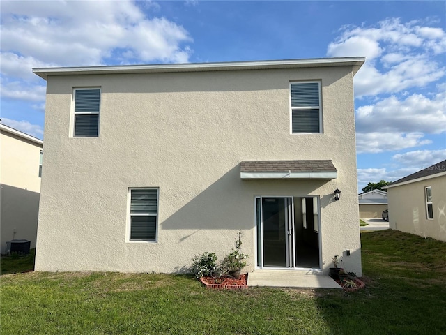 3009 Tansy St, Tavares, FL 32778 - back of house with central air condition unit, a lawn, and stucco siding