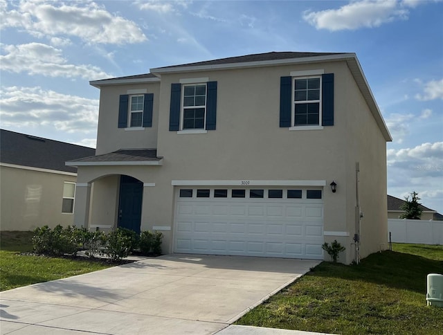 3009 Tansy St, Tavares, FL 32778 - traditional home with stucco siding, an attached garage, a front yard, and driveway