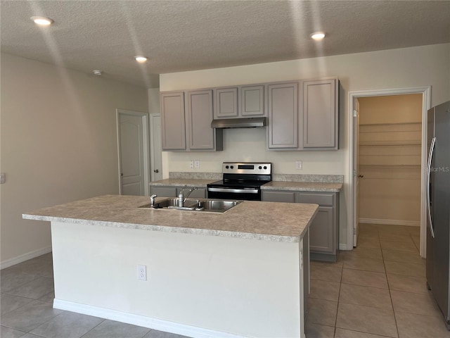 3009 Tansy St, Tavares, FL 32778 - kitchen with a sink, gray cabinetry, under cabinet range hood, light tile patterned floors, and stainless steel appliances