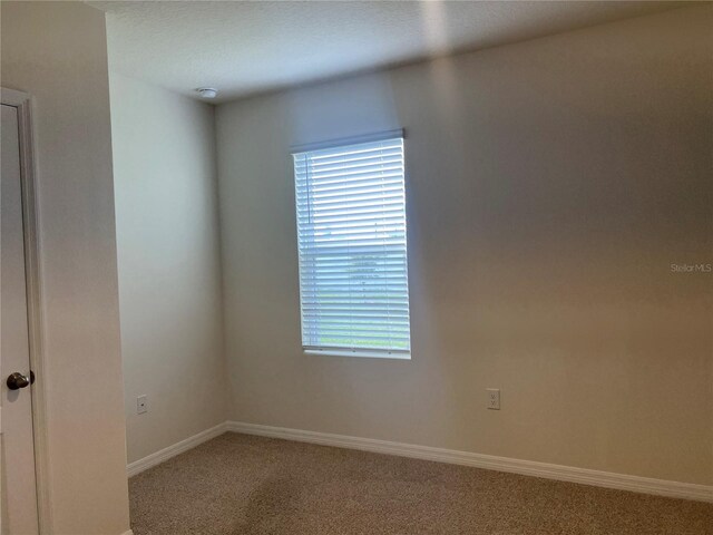 3009 Tansy St, Tavares, FL 32778 - empty room with baseboards and carpet floors
