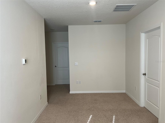 3009 Tansy St, Tavares, FL 32778 - spare room featuring baseboards, a textured ceiling, visible vents, and carpet