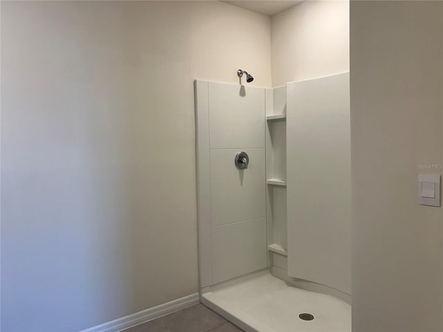 3009 Tansy St, Tavares, FL 32778 - bathroom with tile patterned floors, baseboards, and a shower stall