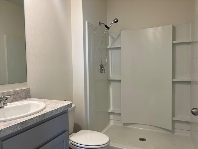 3009 Tansy St, Tavares, FL 32778 - full bathroom with toilet, vanity, and a stall shower