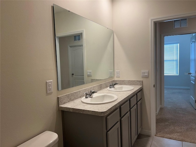 3009 Tansy St, Tavares, FL 32778 - full bath with double vanity, toilet, baseboards, and a sink