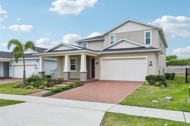 2785 Park Ridge St, Apopka, FL 32712 - craftsman inspired home featuring decorative driveway, a porch, stucco siding, a front yard, and an attached garage
