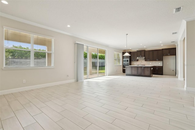 2785 Park Ridge St, Apopka, FL 32712 - unfurnished living room with recessed lighting and crown molding
