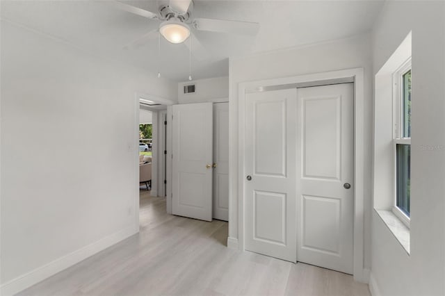 239 S Lake Cortez Dr, Apopka, FL 32703 - unfurnished bedroom with light wood-style flooring, baseboards, and a ceiling fan