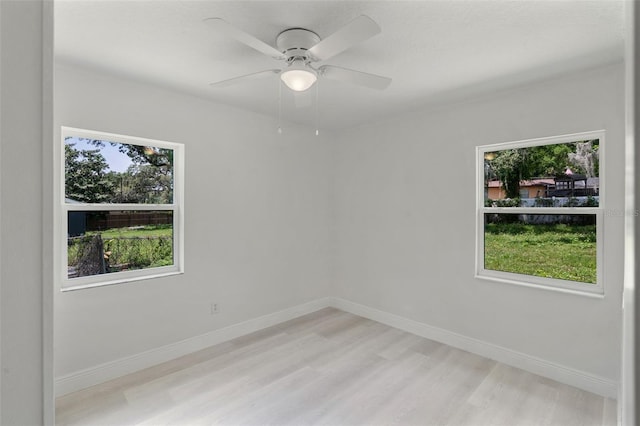 239 S Lake Cortez Dr, Apopka, FL 32703 - unfurnished room featuring plenty of natural light, light wood-style floors, and baseboards