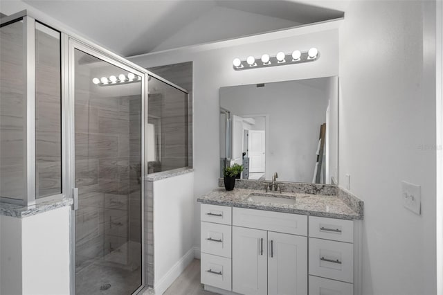 239 S Lake Cortez Dr, Apopka, FL 32703 - full bath with a shower stall, vanity, vaulted ceiling, and baseboards