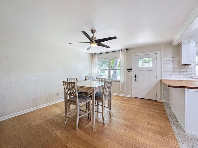 1121 49th Ave N, Saint Petersburg, FL 33703 - dining area featuring baseboards, a ceiling fan, and light wood finished floors