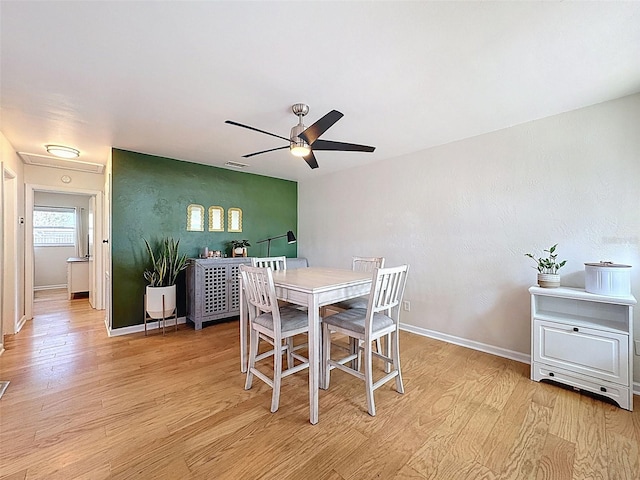 1121 49th Ave N, Saint Petersburg, FL 33703 - dining space featuring light wood finished floors, baseboards, and a ceiling fan