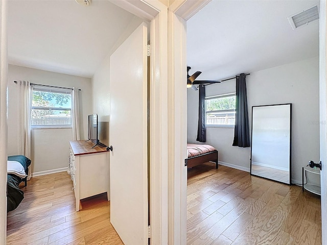 1121 49th Ave N, Saint Petersburg, FL 33703 - hallway with baseboards, light wood finished floors, and visible vents