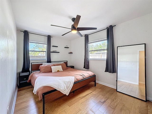 1121 49th Ave N, Saint Petersburg, FL 33703 - bedroom featuring a ceiling fan, light wood-style flooring, and baseboards
