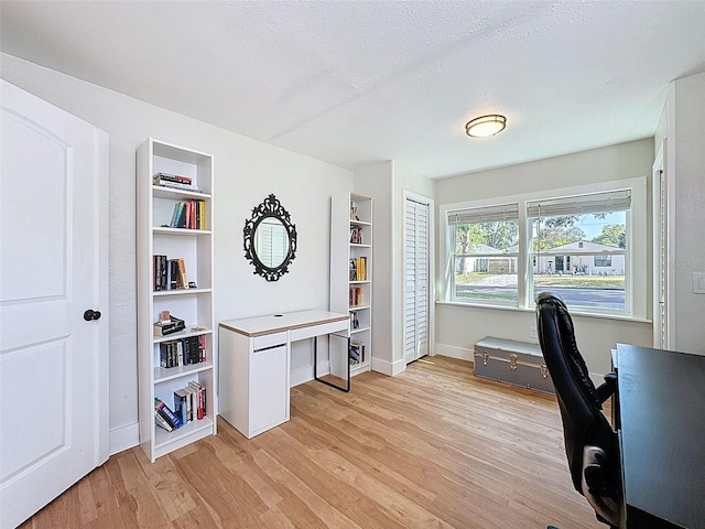 1121 49th Ave N, Saint Petersburg, FL 33703 - office featuring built in features, a textured ceiling, baseboards, and light wood-style floors