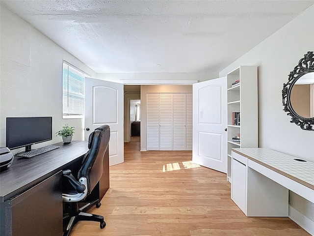 1121 49th Ave N, Saint Petersburg, FL 33703 - home office featuring light wood-style flooring and a textured ceiling
