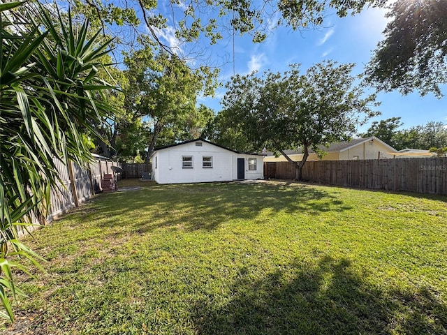 1121 49th Ave N, Saint Petersburg, FL 33703 - view of yard with a fenced backyard and an outbuilding