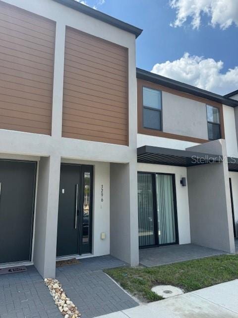 3296 Tranquil Trl, Kissimmee, FL 34747 - rear view of property featuring stucco siding