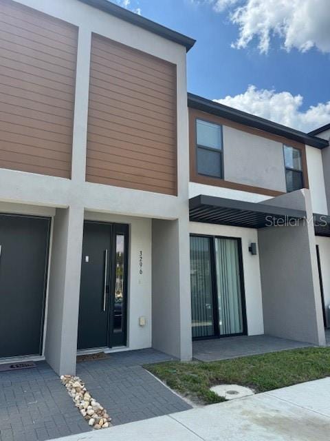 3296 Tranquil Trl, Kissimmee, FL 34747 - view of exterior entry featuring stucco siding