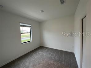 3296 Tranquil Trl, Kissimmee, FL 34747 - carpeted empty room featuring baseboards