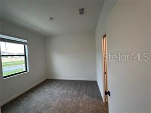 3296 Tranquil Trl, Kissimmee, FL 34747 - carpeted empty room featuring baseboards