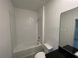 3296 Tranquil Trl, Kissimmee, FL 34747 - bathroom with toilet, shower / bath combination, and vanity