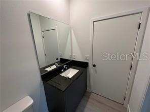 3296 Tranquil Trl, Kissimmee, FL 34747 - bathroom featuring vanity, toilet, and wood finished floors