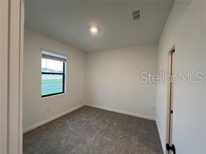 3296 Tranquil Trl, Kissimmee, FL 34747 - carpeted empty room with baseboards