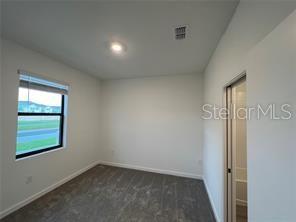 3296 Tranquil Trl, Kissimmee, FL 34747 - unfurnished room with carpet and baseboards