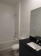3296 Tranquil Trl, Kissimmee, FL 34747 - bathroom with vanity, toilet, and  shower combination