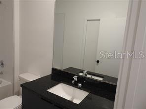 3296 Tranquil Trl, Kissimmee, FL 34747 - full bathroom with vanity, toilet, and bathtub / shower combination