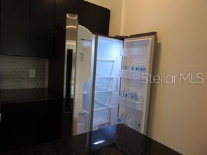 3296 Tranquil Trl, Kissimmee, FL 34747 - kitchen featuring dark cabinets and dark countertops