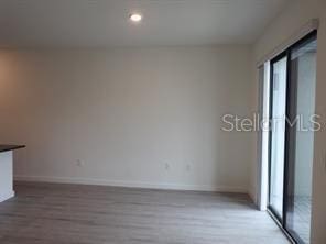 3296 Tranquil Trl, Kissimmee, FL 34747 - empty room featuring wood finished floors, baseboards, and recessed lighting