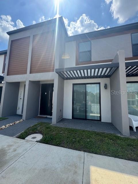 3296 Tranquil Trl, Kissimmee, FL 34747 - rear view of house featuring stucco siding