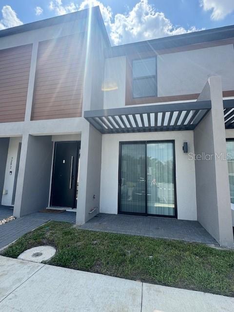 3296 Tranquil Trl, Kissimmee, FL 34747 - rear view of property with stucco siding