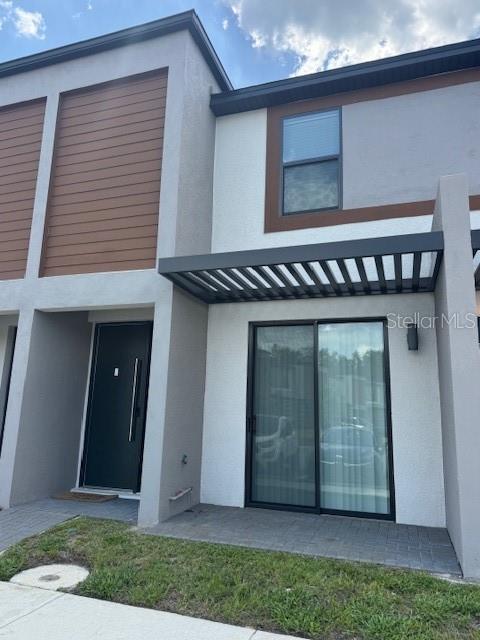 3296 Tranquil Trl, Kissimmee, FL 34747 - rear view of house featuring stucco siding