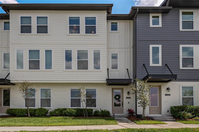 12330 Koshiba Aly, Orlando, FL 32827 - multi unit property featuring board and batten siding and brick siding