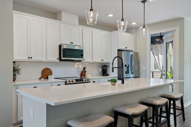 12330 Koshiba Aly, Orlando, FL 32827 - kitchen featuring white cabinetry, tasteful backsplash, a sink, and stainless steel appliances