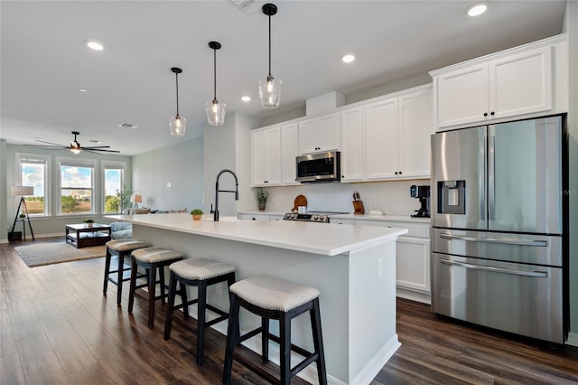 12330 Koshiba Aly, Orlando, FL 32827 - kitchen with dark wood finished floors, a sink, white cabinetry, and appliances with stainless steel finishes