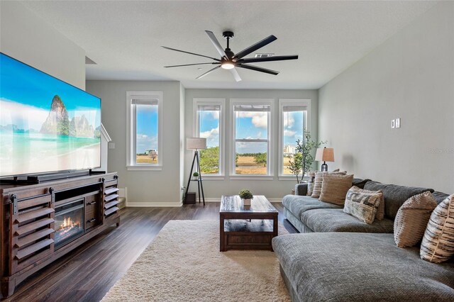 12330 Koshiba Aly, Orlando, FL 32827 - living room featuring baseboards, wood finished floors, a glass covered fireplace, and a ceiling fan
