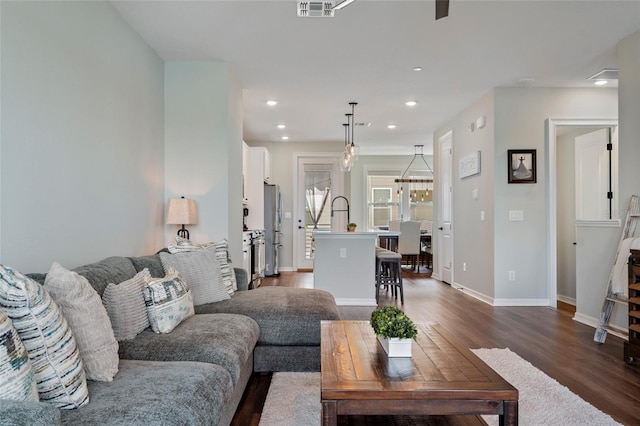 12330 Koshiba Aly, Orlando, FL 32827 - living area featuring baseboards, dark wood-style floors, visible vents, and recessed lighting