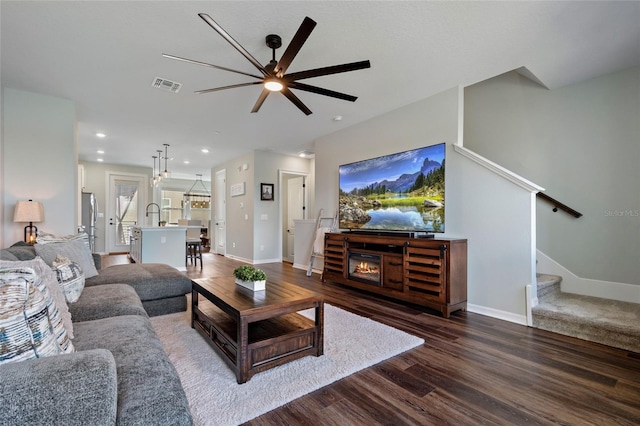 12330 Koshiba Aly, Orlando, FL 32827 - living area featuring stairs, dark wood-type flooring, baseboards, ceiling fan, and visible vents