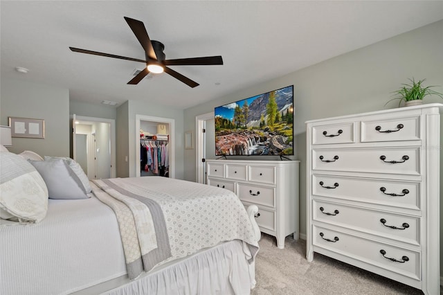 12330 Koshiba Aly, Orlando, FL 32827 - bedroom featuring a ceiling fan, a walk in closet, a closet, and light colored carpet