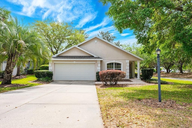 39900 Bayview Dr, Lady Lake, FL 32159 - single story home featuring stucco siding, a garage, concrete driveway, and a front yard