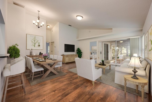 39900 Bayview Dr, Lady Lake, FL 32159 - living room with visible vents, high vaulted ceiling, a chandelier, and wood finished floors