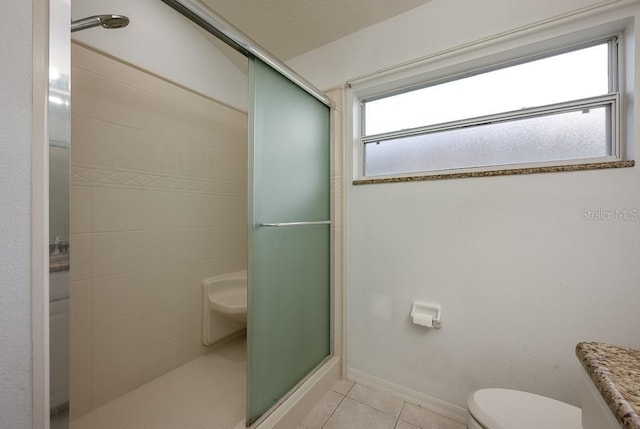 39900 Bayview Dr, Lady Lake, FL 32159 - bathroom featuring toilet, tile patterned floors, baseboards, and a shower stall