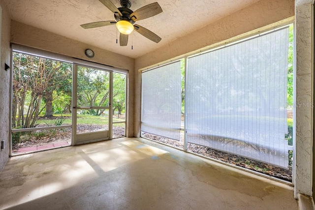 39900 Bayview Dr, Lady Lake, FL 32159 - unfurnished sunroom featuring unfinished concrete flooring, a healthy amount of sunlight, and ceiling fan